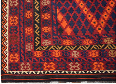 Handwoven Afghan Maimana kilim featuring a geometric pattern in red, blue, and orange wool.