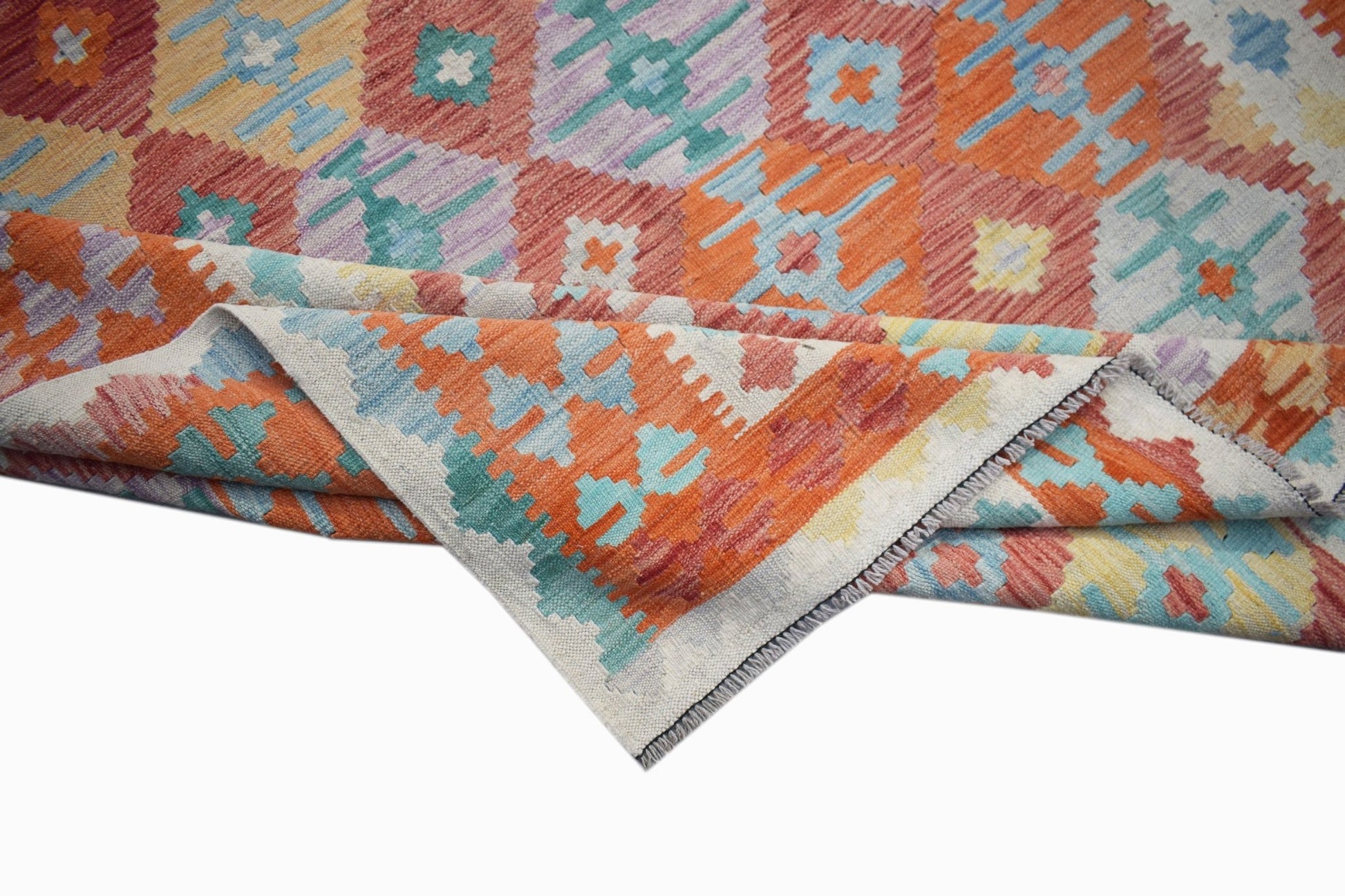 A handwoven Afghan Maimana kilim rug featuring a colorful geometric pattern in wool.