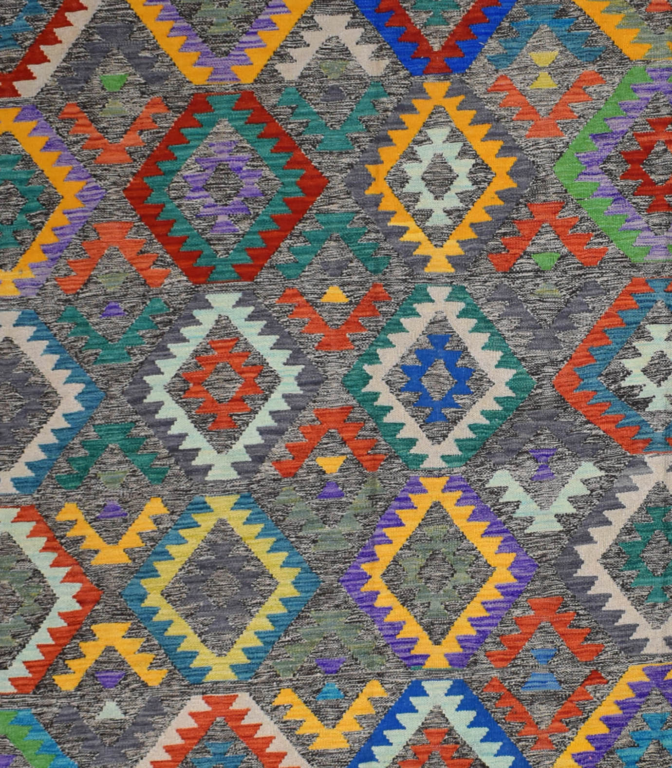 Handmade Afghan Maimana kilim rug featuring a vibrant geometric diamond pattern on a grey field.
