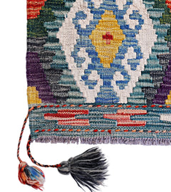 Handwoven Afghan Maimana kilim featuring a geometric pattern in blue, yellow, and red wool.