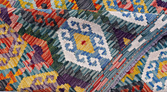 A handwoven Afghan Maimana kilim rug featuring a vibrant geometric pattern in wool.