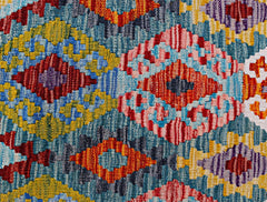 Handwoven Afghan Maimana kilim featuring a vibrant geometric pattern in wool.
