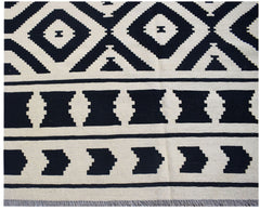 Handwoven Afghan Maimana kilim rug featuring a black and cream geometric pattern.