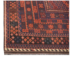 Handwoven Afghan Maimana kilim rug featuring geometric patterns in red, blue, and brown tones.