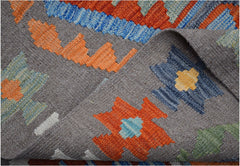 Handwoven Afghan Maimana kilim featuring a grey background with colorful geometric patterns.
