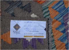 A handwoven Afghan Maimana kilim rug featuring a geometric pattern in orange, blue, and purple.