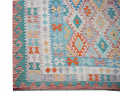 A handmade Afghan Maimana kilim rug featuring a geometric pattern in vibrant multicolored tones.