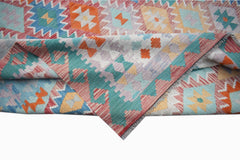 Handwoven Afghan Maimana kilim rug featuring a colorful geometric pattern in wool.