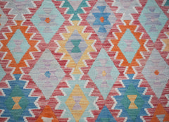 Handwoven Afghan Maimana kilim featuring a colorful geometric diamond pattern in wool.