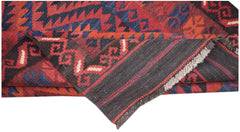 A handwoven Afghan Maimana kilim runner featuring geometric patterns in red, blue, and black wool.