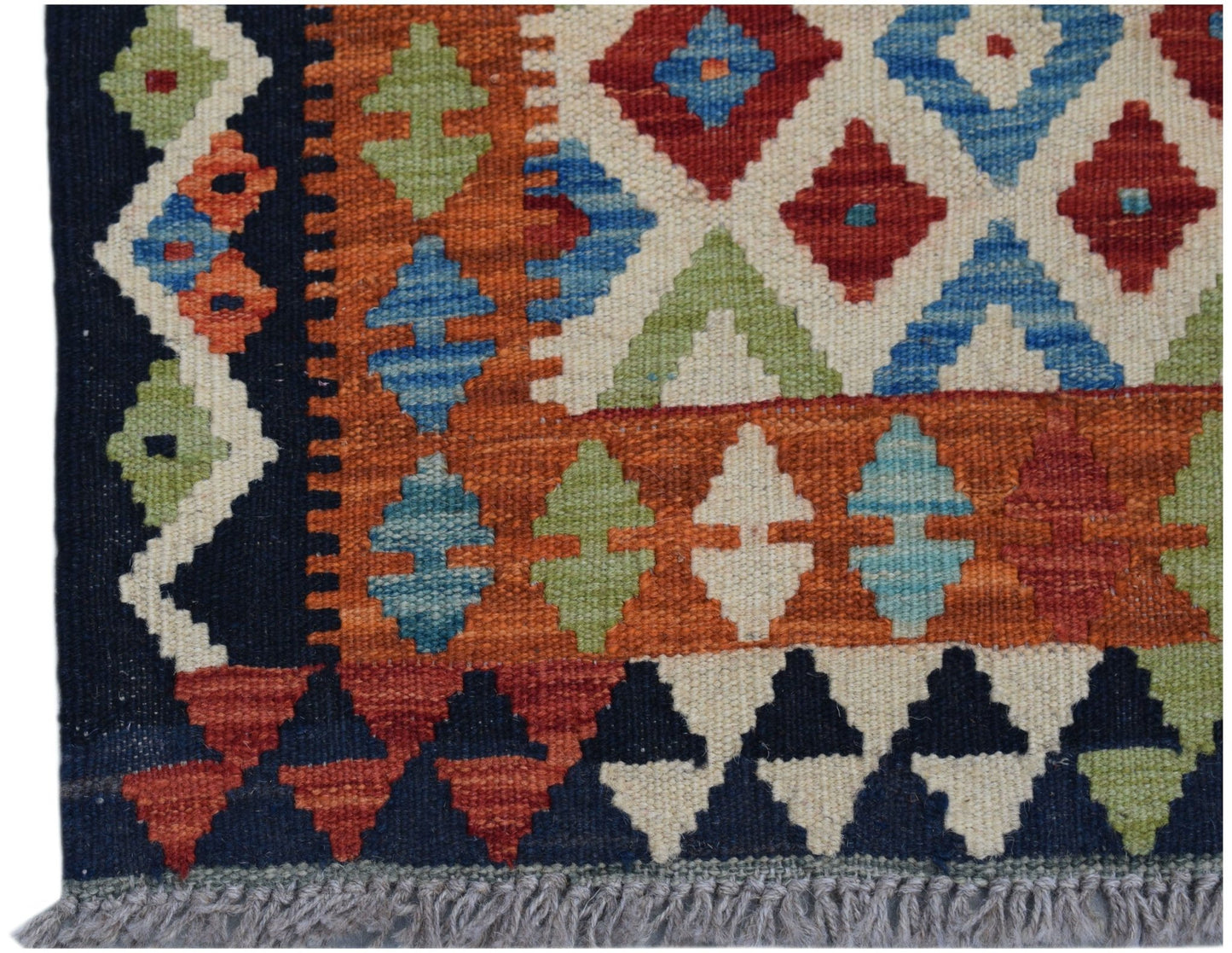 A handmade Afghan Maimana kilim runner featuring a geometric pattern in vibrant wool colors.