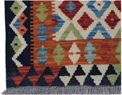 A handmade Afghan Maimana kilim runner featuring a geometric pattern in vibrant wool colors.