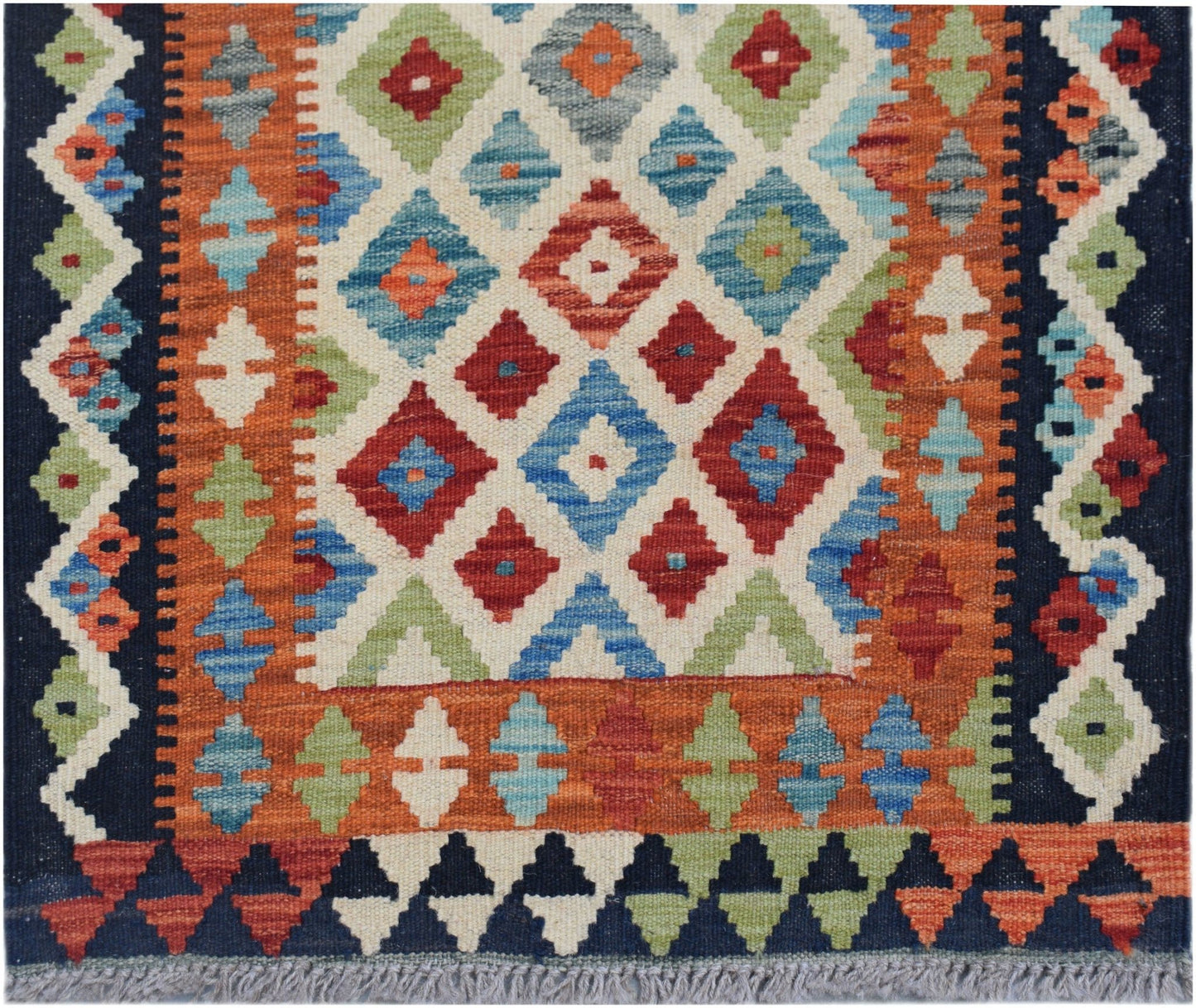 Handwoven Afghan Maimana wool runner featuring a colorful geometric diamond pattern.