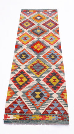 Handwoven Afghan Maimana wool runner rug featuring a colorful geometric diamond pattern.