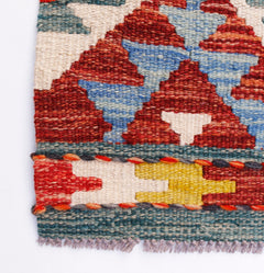 Handwoven Afghan Maimana wool kilim runner featuring geometric patterns in red, blue, and yellow.