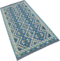 A handmade Afghan Maimana wool runner rug featuring a blue and cream geometric diamond pattern.