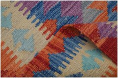 A handmade Afghan Maimana kilim runner featuring a geometric pattern in vibrant wool colors.
