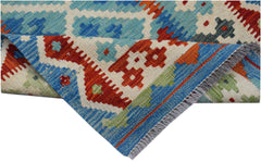A handmade Afghan Maimana kilim runner featuring a geometric pattern in blue, red, and green wool.