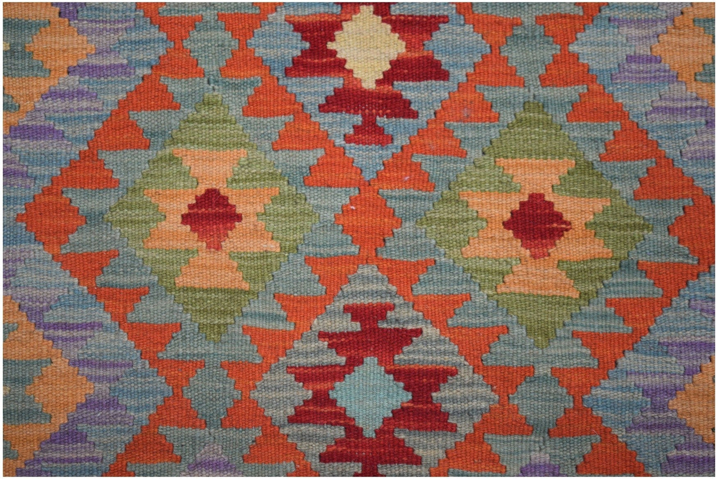 Handmade Afghan Maimana kilim runner featuring a vibrant geometric diamond pattern in wool.