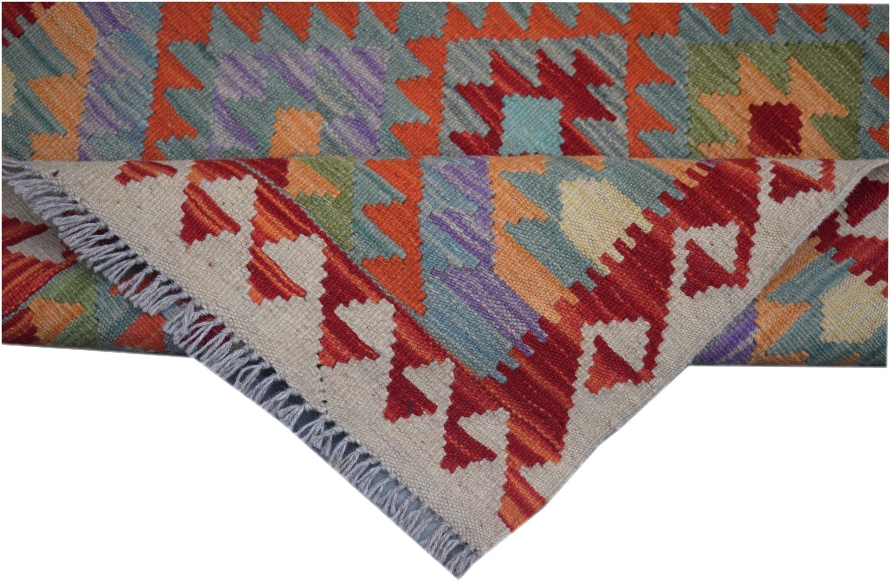 A handmade Afghan Maimana kilim runner featuring colorful geometric patterns and a fringed edge.