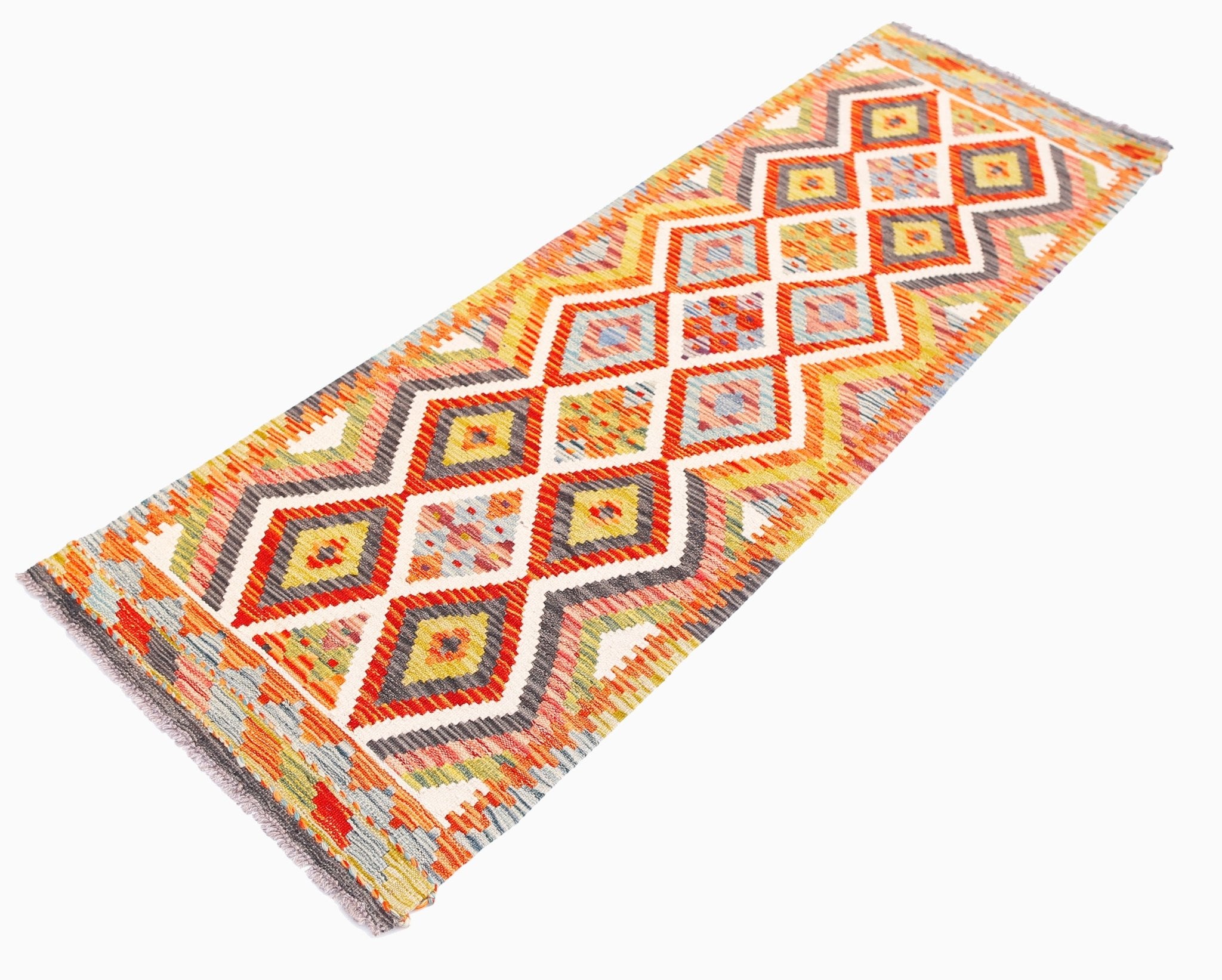A handmade Afghan Maimana wool runner rug featuring a vibrant geometric diamond pattern.