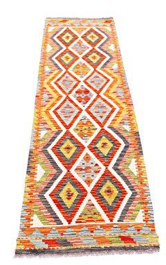 Handwoven Afghan Maimana wool runner rug featuring a colorful geometric diamond pattern.