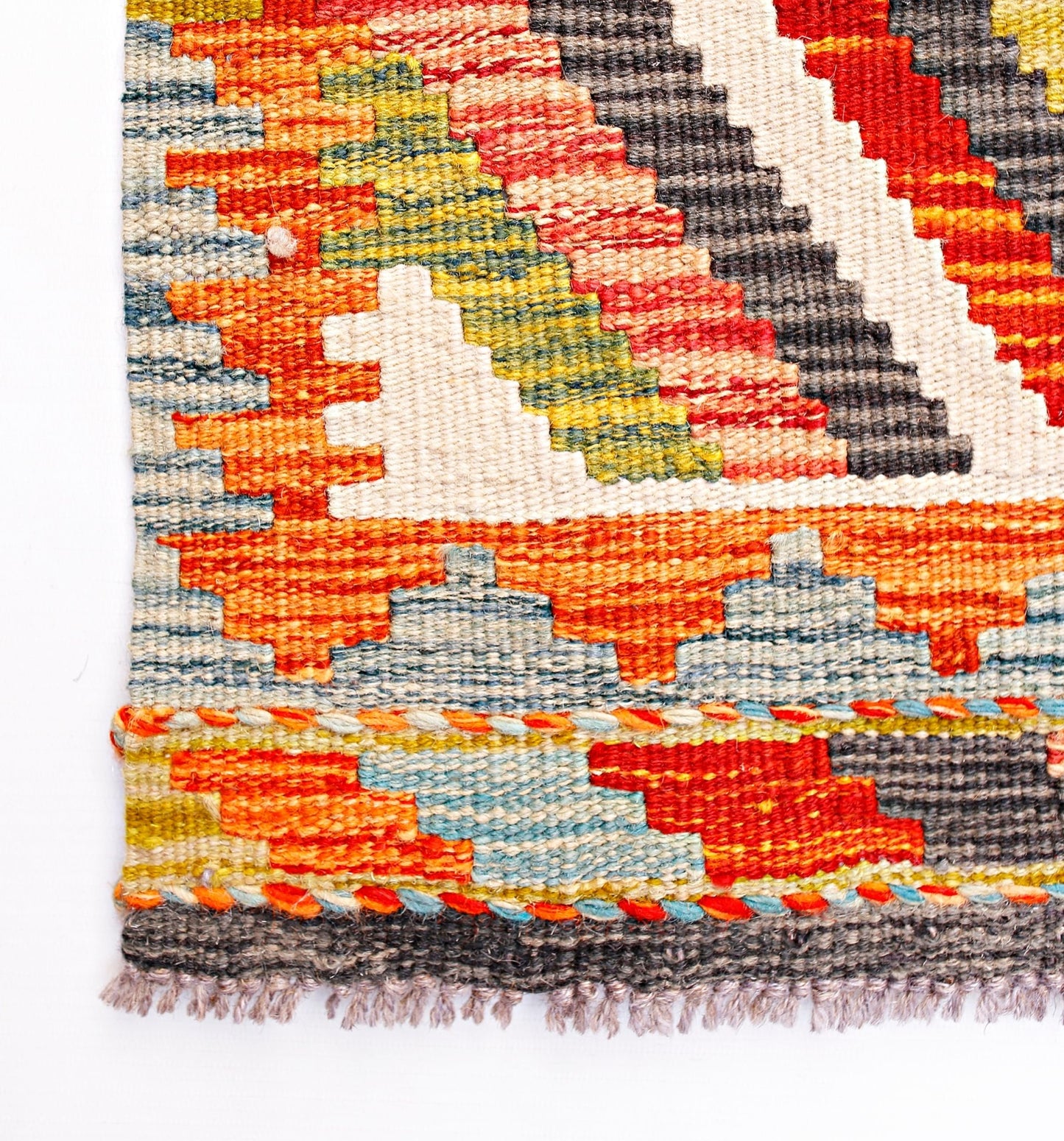 Handwoven Afghan Maimana wool kilim runner featuring a geometric pattern in vibrant colors.