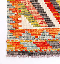 Handwoven Afghan Maimana wool kilim runner featuring a geometric pattern in vibrant colors.
