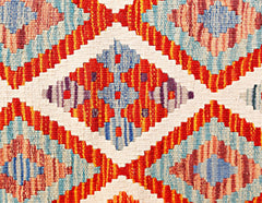 A handmade Afghan Maimana kilim runner featuring a geometric diamond pattern in vibrant colors.