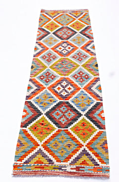 Handwoven Afghan Maimana wool runner rug featuring a colorful geometric diamond pattern.
