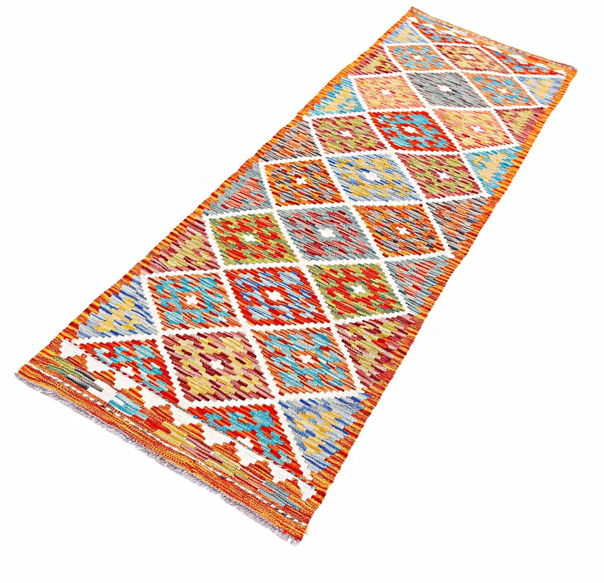 A handmade Afghan Maimana wool runner rug featuring a colorful geometric diamond pattern.