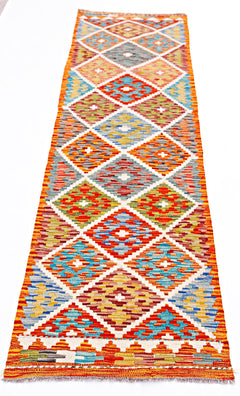 Handwoven Afghan Maimana wool runner rug featuring a colorful geometric diamond pattern.