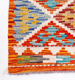 Handwoven Afghan Maimana wool kilim runner featuring a vibrant geometric pattern.