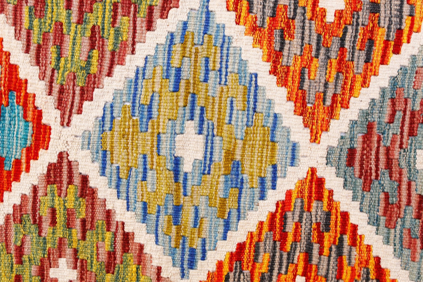 Handwoven Afghan Maimana kilim runner featuring a vibrant geometric diamond pattern in wool.