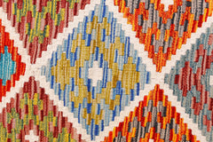Handwoven Afghan Maimana kilim runner featuring a vibrant geometric diamond pattern in wool.