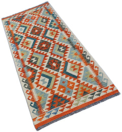 Handwoven Afghan Maimana wool runner rug featuring a colorful geometric diamond pattern.