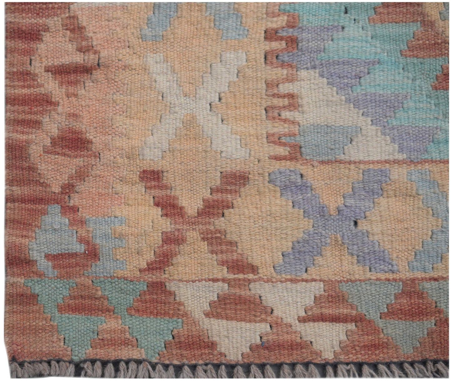 Handmade Afghan Maimana kilim runner featuring a geometric pattern in muted earth tones.