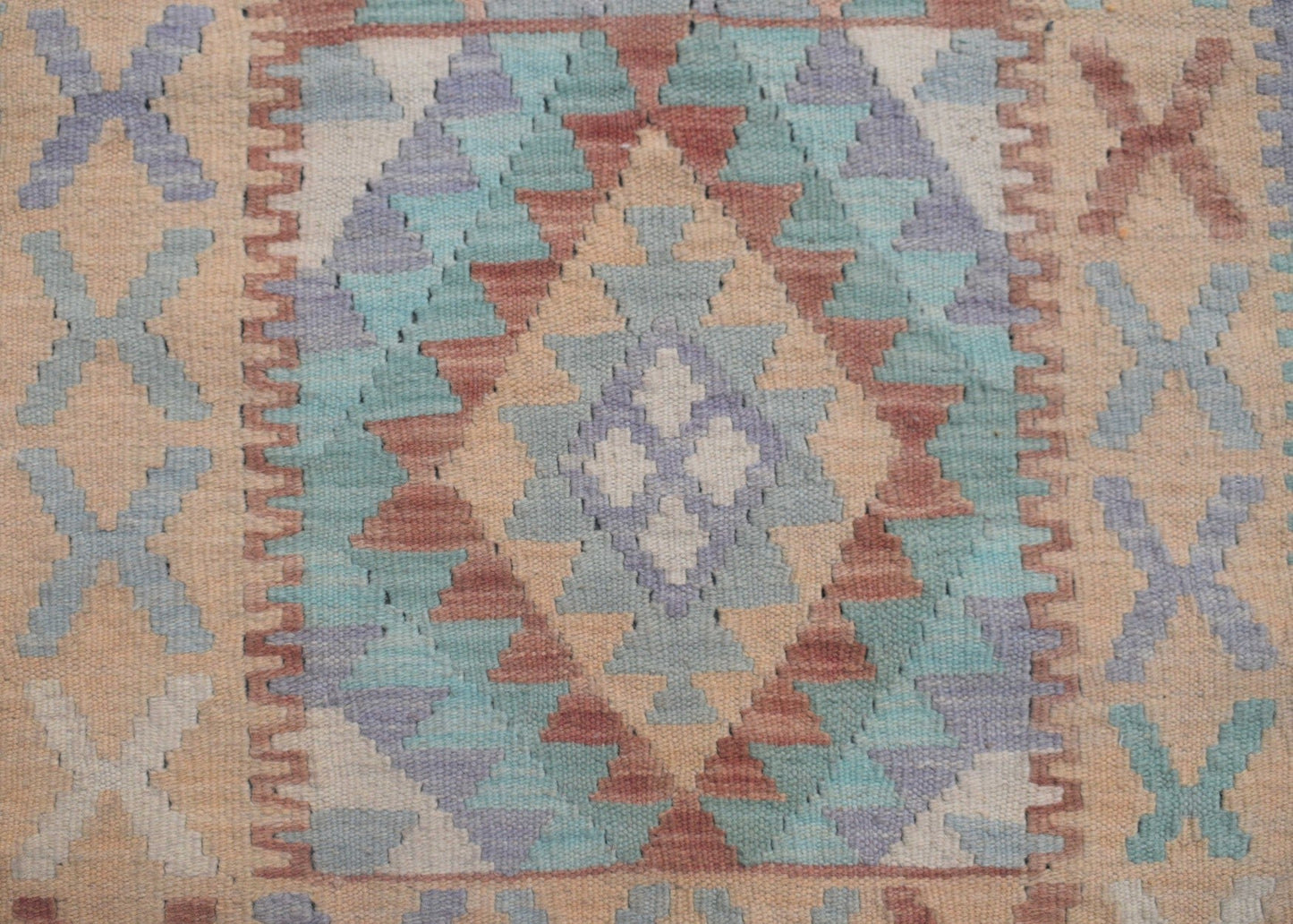 Handmade Afghan Maimana kilim runner featuring a geometric diamond pattern in muted earth tones.