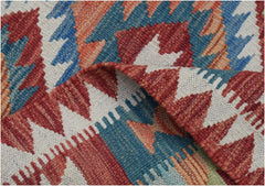 A handmade Afghan Maimana wool kilim runner featuring a geometric pattern in red, blue, and cream.