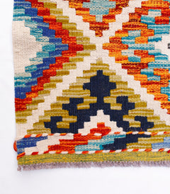 Handwoven Afghan Maimana wool kilim runner featuring a vibrant geometric pattern.