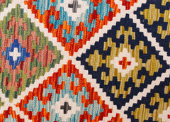 Handwoven Afghan Maimana kilim runner featuring a vibrant geometric diamond pattern in wool.