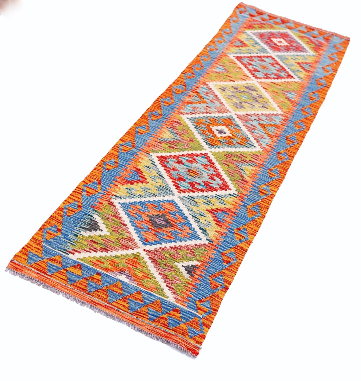 A handmade Afghan Maimana wool runner rug featuring a vibrant geometric diamond pattern.