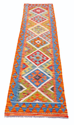 A handmade Afghan Maimana wool runner rug featuring a vibrant geometric diamond pattern.