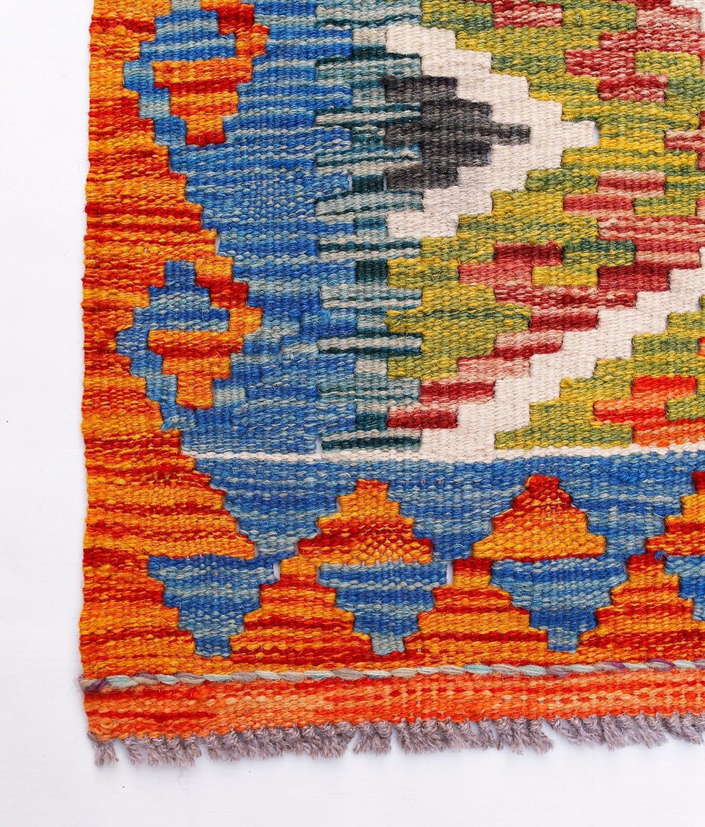 Handwoven Afghan Maimana wool kilim runner featuring a vibrant geometric pattern.