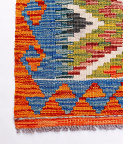 Handwoven Afghan Maimana wool kilim runner featuring a vibrant geometric pattern.