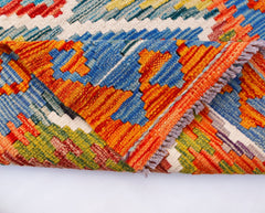 A handwoven Afghan Maimana kilim runner featuring vibrant geometric patterns in wool.