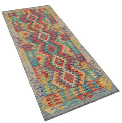Afghan Maimana Kilim runner with geometric patterns in multiple colors.