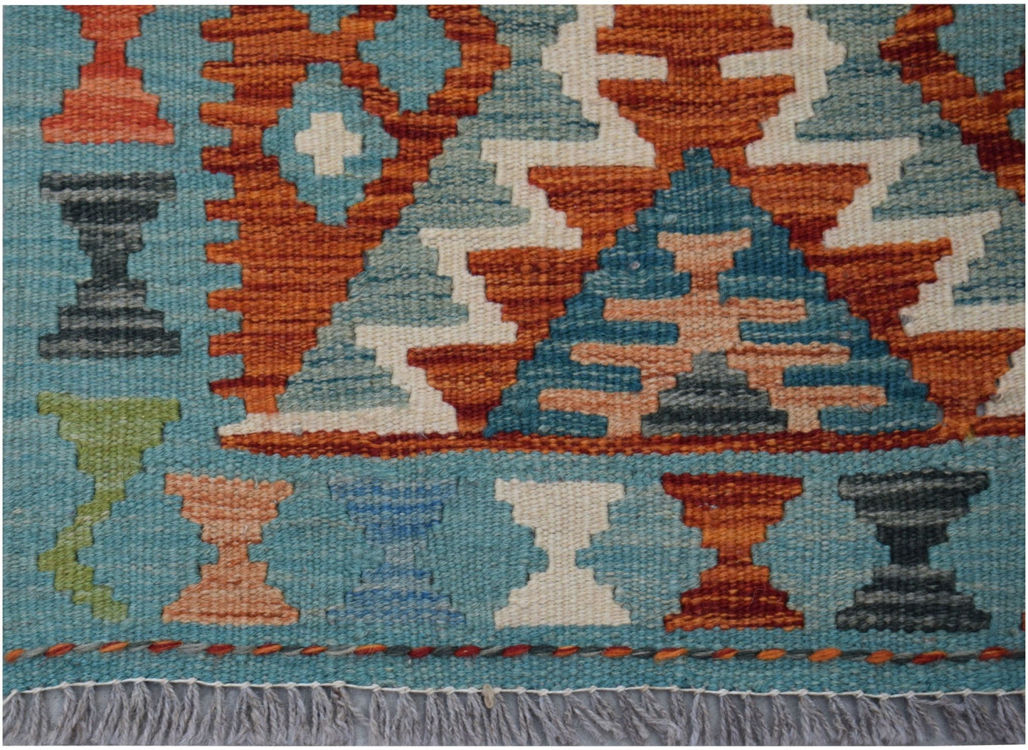 Handwoven Afghan Maimana wool kilim runner featuring geometric patterns in blue and orange tones.