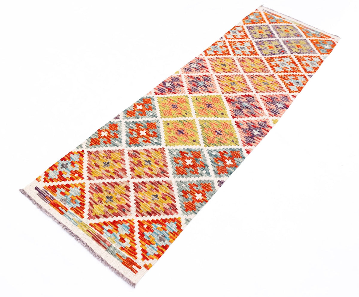 Handwoven Afghan Maimana wool runner rug featuring a colorful geometric diamond pattern.