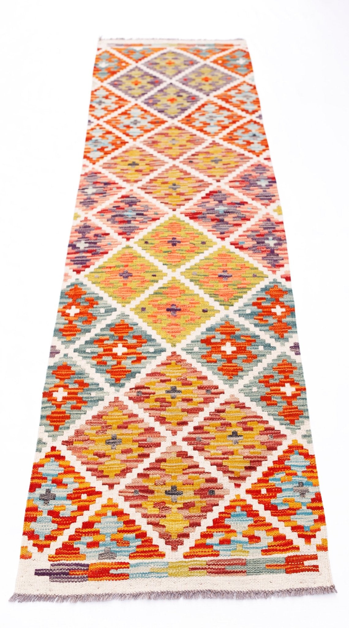Handwoven Afghan Maimana wool runner rug featuring a colorful geometric diamond pattern.
